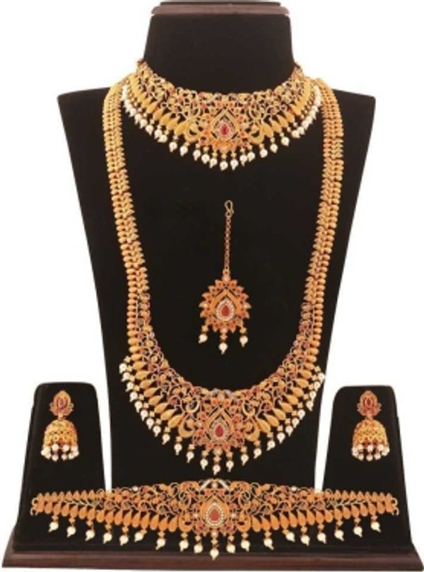 Alloy Jewel SetColor :MulticolorColor Code :NAModel Number :SHOPSY-5968Sales Package Id :1 Long Necklace, 1 Choker Necklace, 1 Pair Earrings, 1 Kamarband, 1 MaangtikkaType :Bridal SetBase Material :AlloyPlating :Gold-plated7 Days Return Policy, No questions asked.
