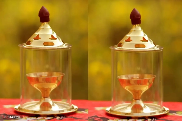 Brass Golden  Akhand Diya - Lamp 4.8 Inch Set Of 2Within 6-8 business days However, to find out an actual date of delivery, please enter your pin code.Heat and Crack Resistant Create a meditative and peaceful ambiance in your puja room with the Heaven Decor Akhand Diya. Even after incessant burning for long hours. It is efficient in emitting brighter light and is safe for use compa