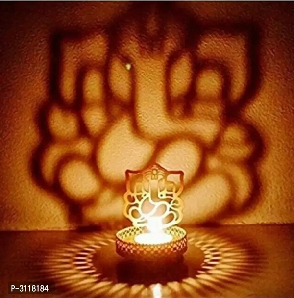 Shadow Ganesh ji  Tealight Candle HolderWithin 6-8 business days However, to find out an actual date of delivery, please enter your pin code.Material: Iron Color: Golden Vibrant and visually appealing, this Ganesh Ji candle tea light holder from the storehouse collection of Heaven Decor exhibits great artisanship. Heaven Decor, a well known brand is known to provide wide range of d