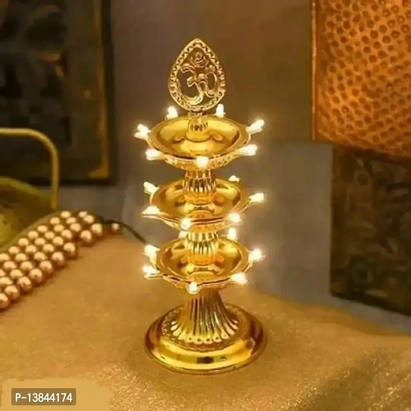 Golden coloured 3 Layer OM Electric 21 Led Diya stand/Diwali Decoration/Diwali pooja/Home Decor Plastic Table Diya (Height: 10 inch) (Pack of 1)Within 6-8 business days However, to find out an actual date of delivery, please enter your pin code.Indian Electrical Plastic Double Layer LED Golden Mayur Design Electric Diya Decorative Lamp for Temple Decoration. 3 Layer Name: Indian El