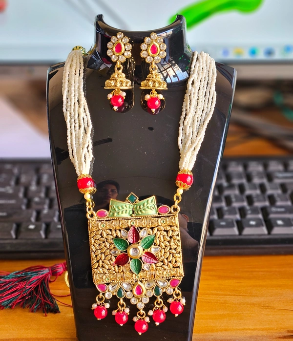 GOLD-PLATED RED-GREEN-WHITE PEARL AND STONE STUDDED ALLOY JEWELLERY SET CONSISTS OF A LONG NECKLACE & A PAIR OF EARRINGS