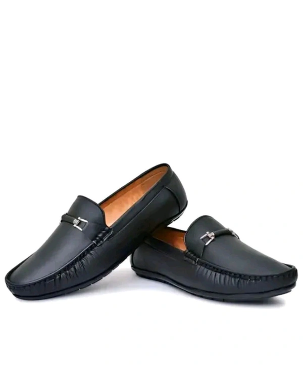 NEW TRENDY BLACK LOAFER
Name: NEW TRENDY BLACK LOAFER
Material: Synthetic
Sole Material: Pvc
Fastening: Slip On
Toe Shape: Round Toe
Net Quantity (N): 1
M.D. Loafer shoes are so comfortable shoes and wearing them looks very good.
Sizes: 
IND-6 (Foot Length Size: 25 cm, Foot Width Size: 10 cm) 
IND-7 (Foot Length Size: 26 cm, Foot Width Size: 10.1 cm - 9