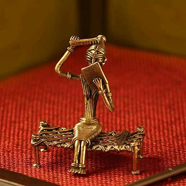 SITTING COMBING ON BED 