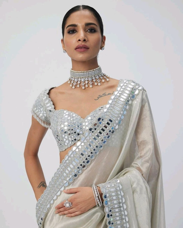 Slay in style with this one of a kind which allures your beauty and soothes your eyes . Here's yet another one of our saree collection which features Sift satin Organza saree which is embedded with real mirror work Embroidery all over the borders  Comes with a a fully embellished standard sized Stitched blouse.
