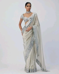 Slay in style with this one of a kind which allures your beauty and soothes your eyes . Here's yet another one of our saree collection which features Sift satin Organza saree which is embedded with real mirror work Embroidery all over the borders  Comes with a a fully embellished standard sized Stitched blouse.
