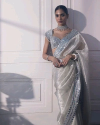 Slay in style with this one of a kind which allures your beauty and soothes your eyes . Here's yet another one of our saree collection which features Sift satin Organza saree which is embedded with real mirror work Embroidery all over the borders  Comes with a a fully embellished standard sized Stitched blouse.
